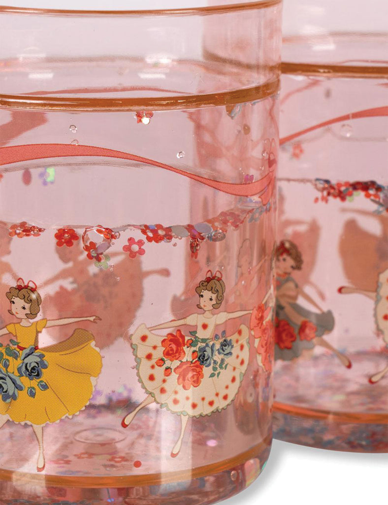 Clear plastic cup with ballerina design on a pink background