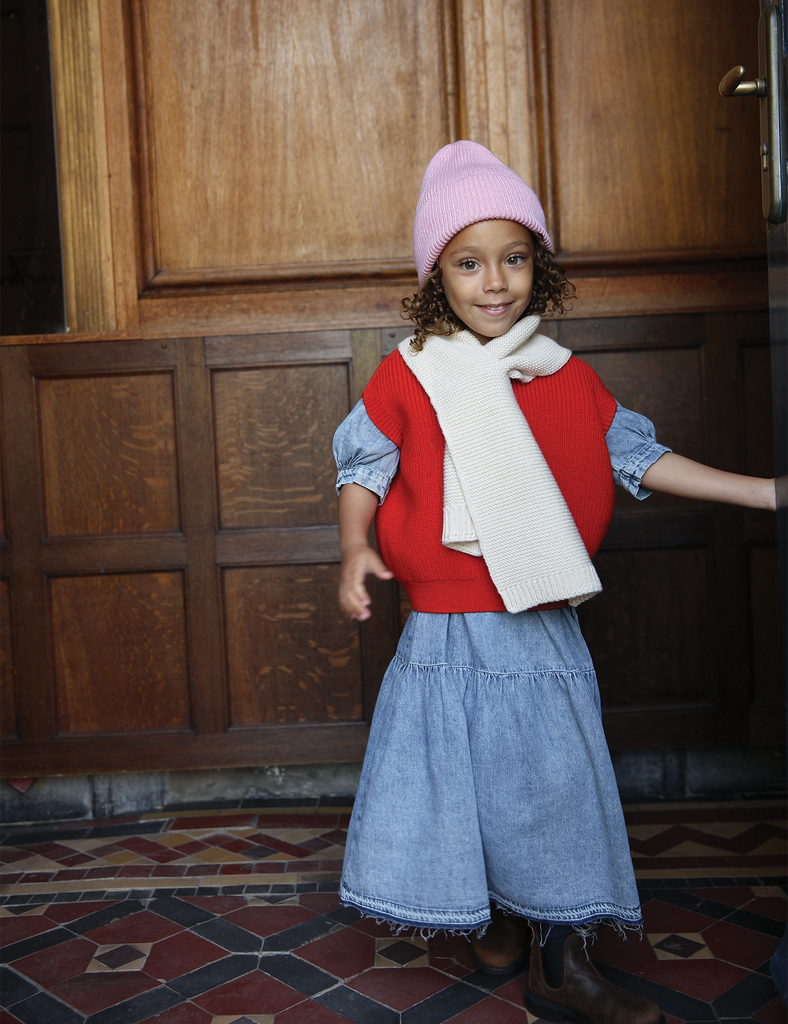 Image of Fonzie Beanie in Cotton Candy on a little girl wearing a red sweater.
