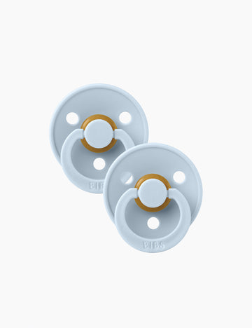 Two light blue pacifiers with gold bands on a white background