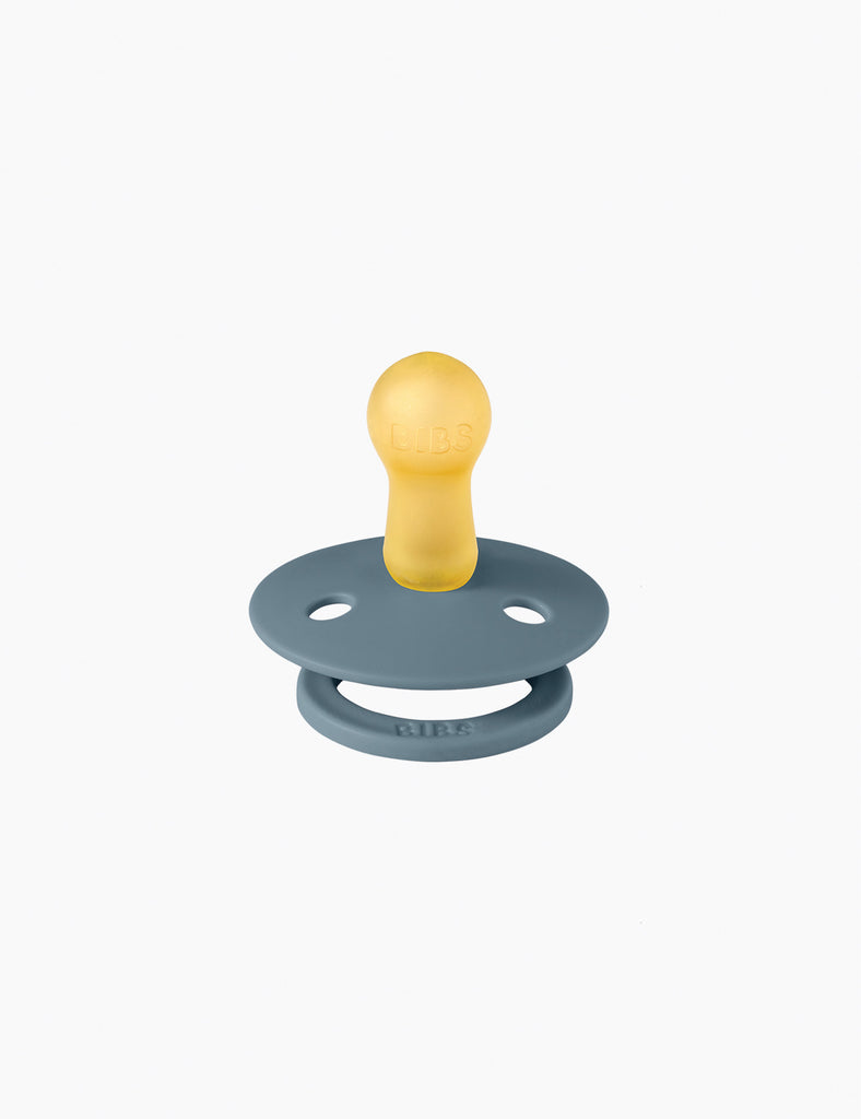 Blue and yellow pacifier on a white background