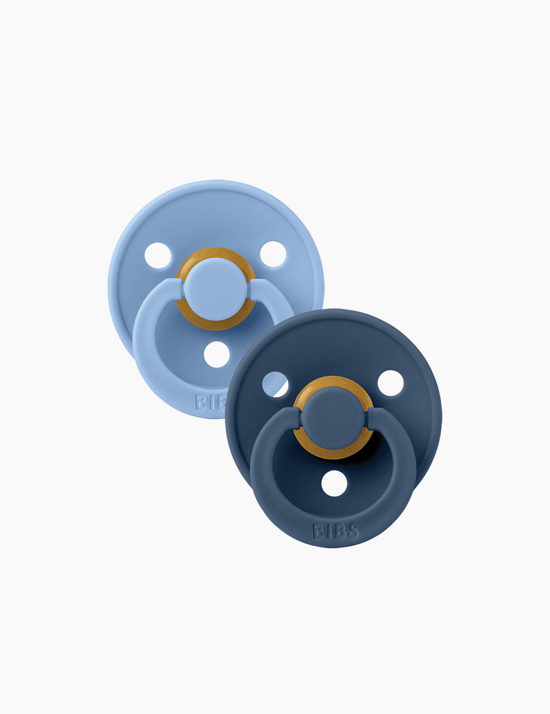 Two baby pacifiers, one blue and one navy, on a white background