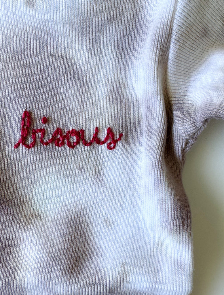 90s tie dye set with bisous embroidery flat lay image.