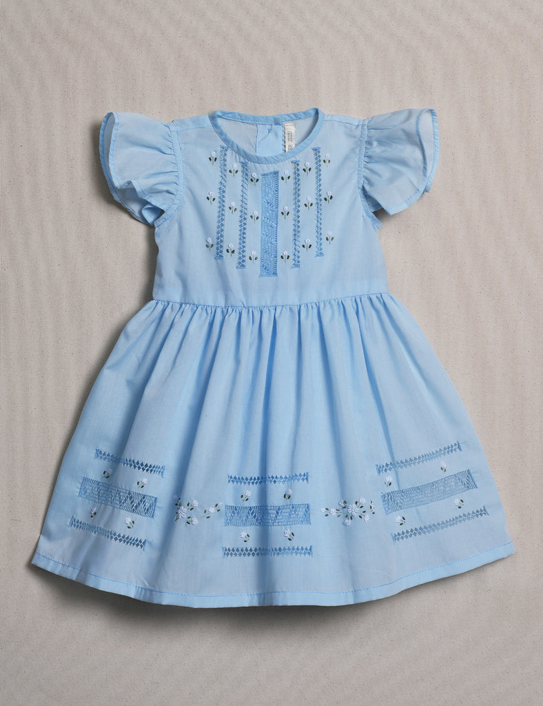 Light blue dress with embroidery on a beige background