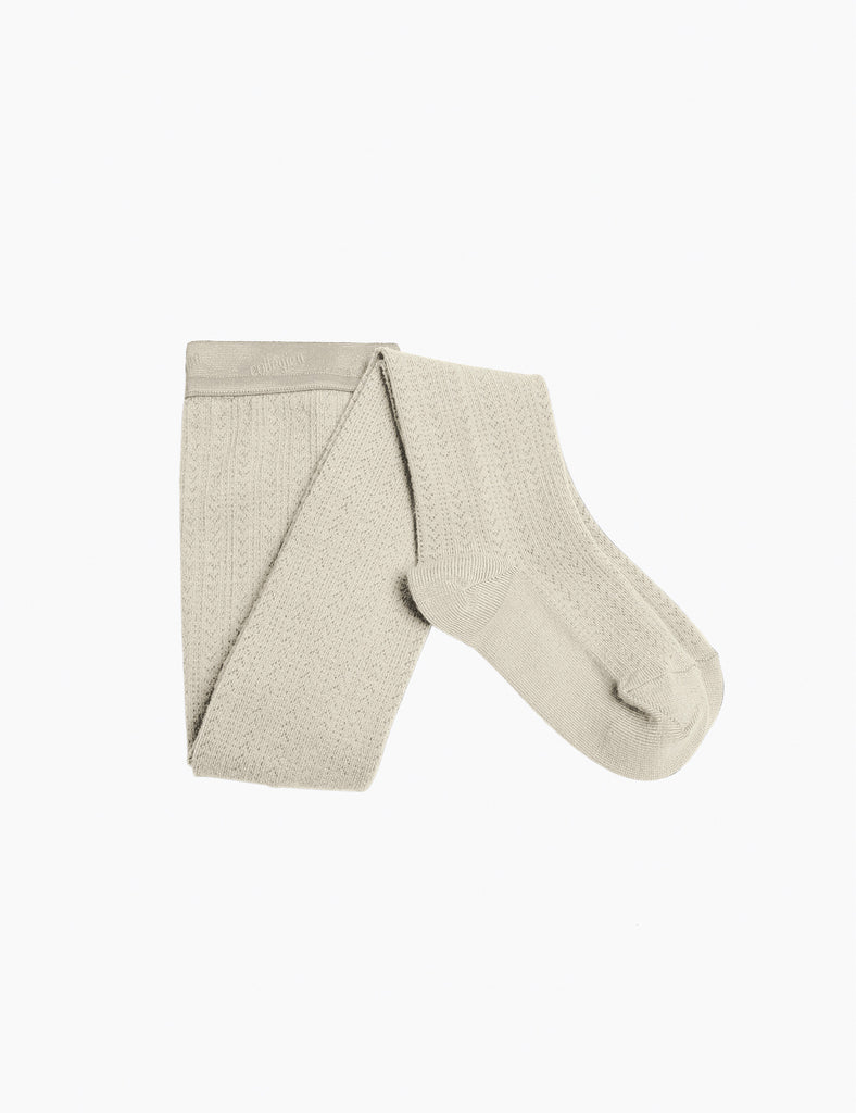 Folded beige tights on a white background