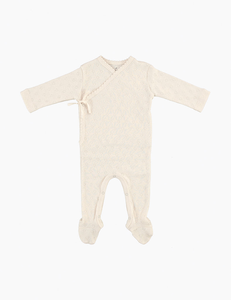 Beige baby onesie with feet on a white background