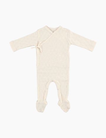 Beige baby onesie with feet on a white background