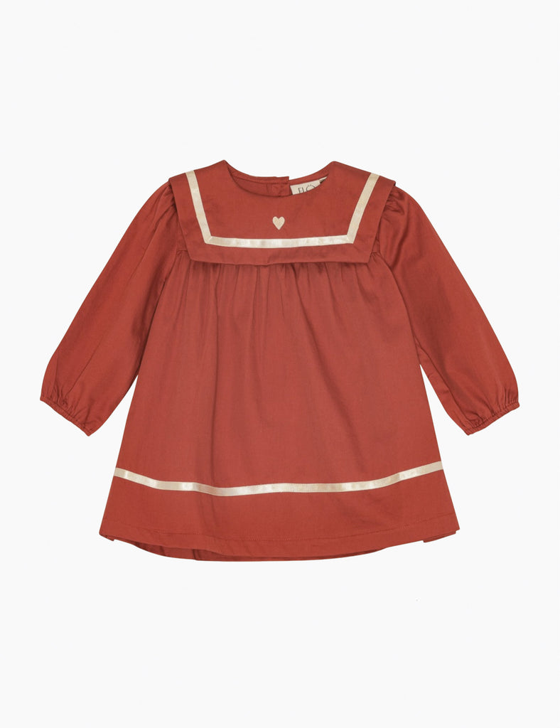 Red dress with white trim on a white background