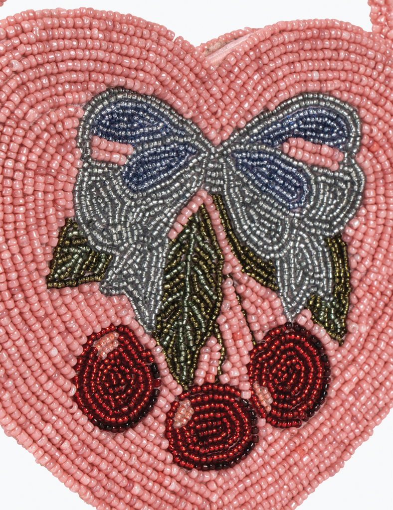 Heart-shaped beaded design with a butterfly and cherries on a pink background