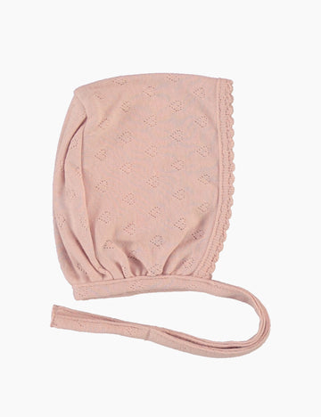 Pink baby bonnet with a strap on a white background