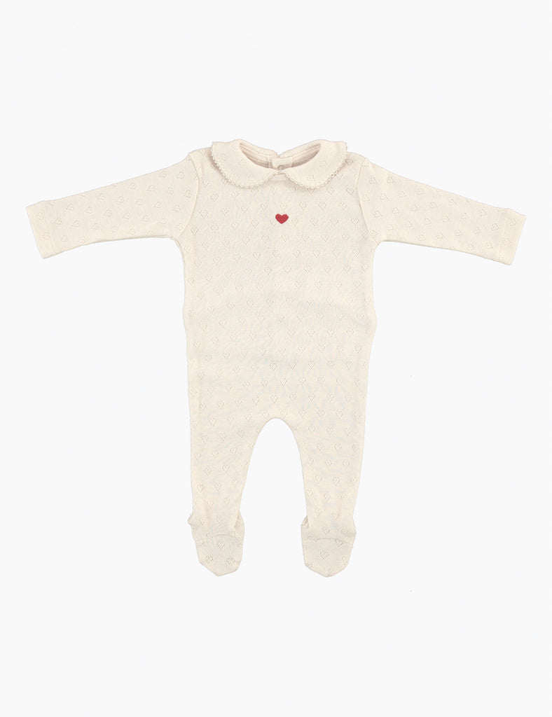 Cream-colored baby onesie with a red heart on a white background