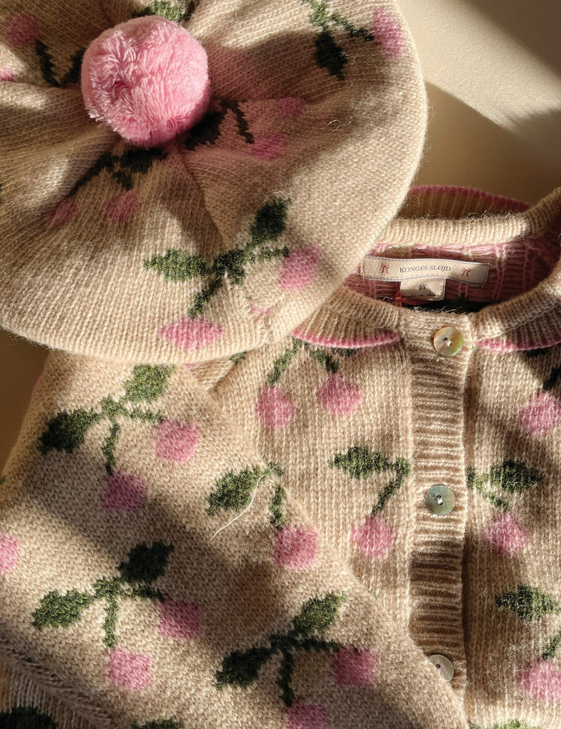 Floral patterned sweater with matching hat on a neutral background
