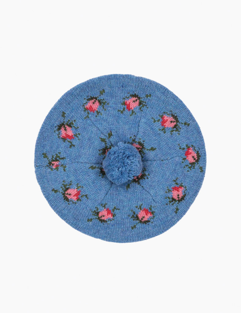 Blue beret with floral embroidery on a white background