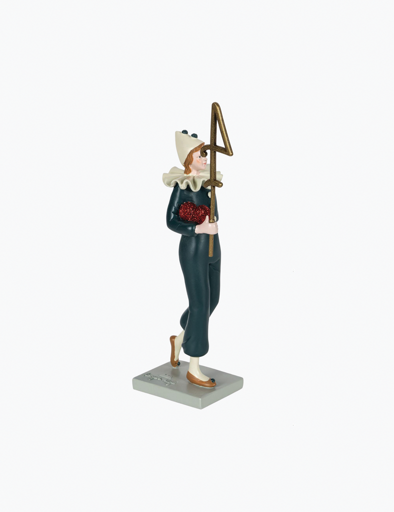 Figurine of a person in historical attire holding a staff on a white background