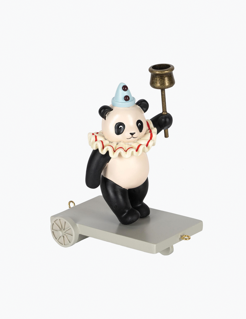 Panda figurine with clown makeup and a bell on a white background