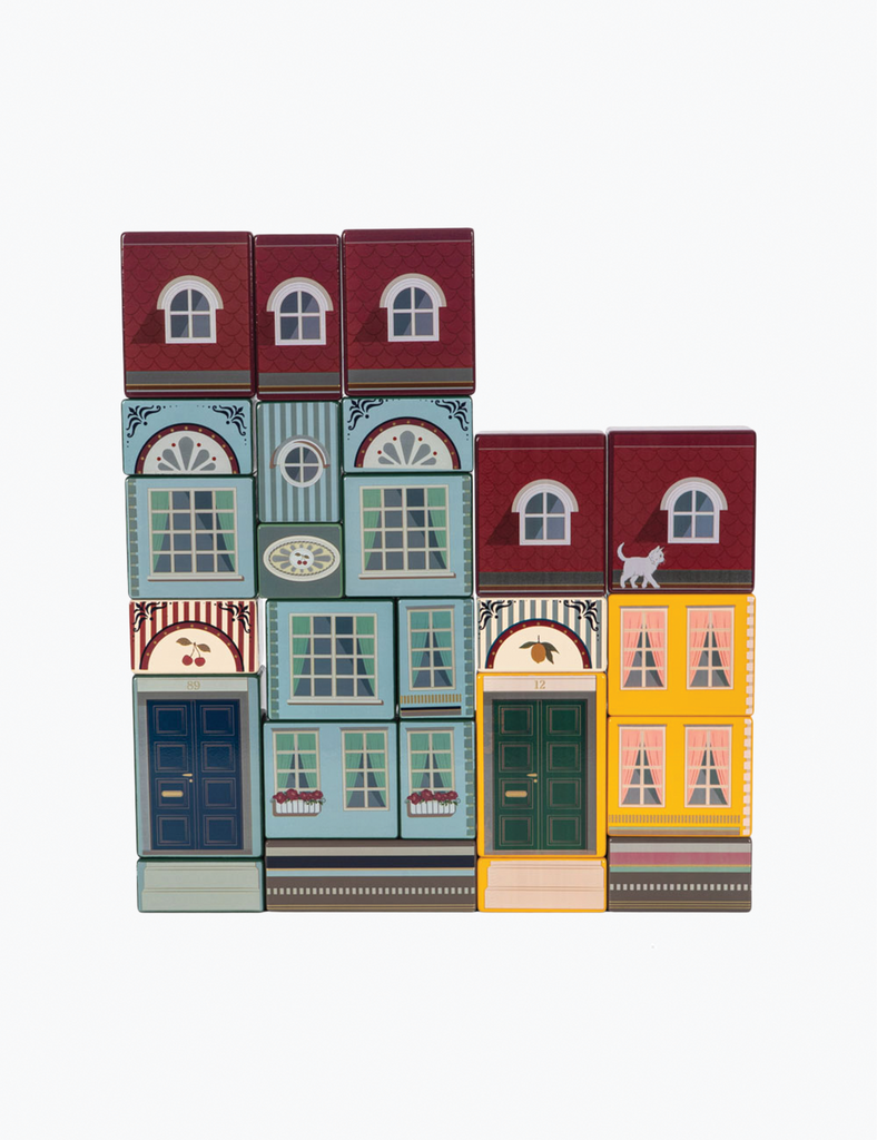 Stack of colorful building blocks with various window designs on a white background