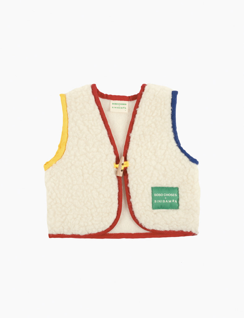 Children's cream-colored vest with colorful trim on a white background