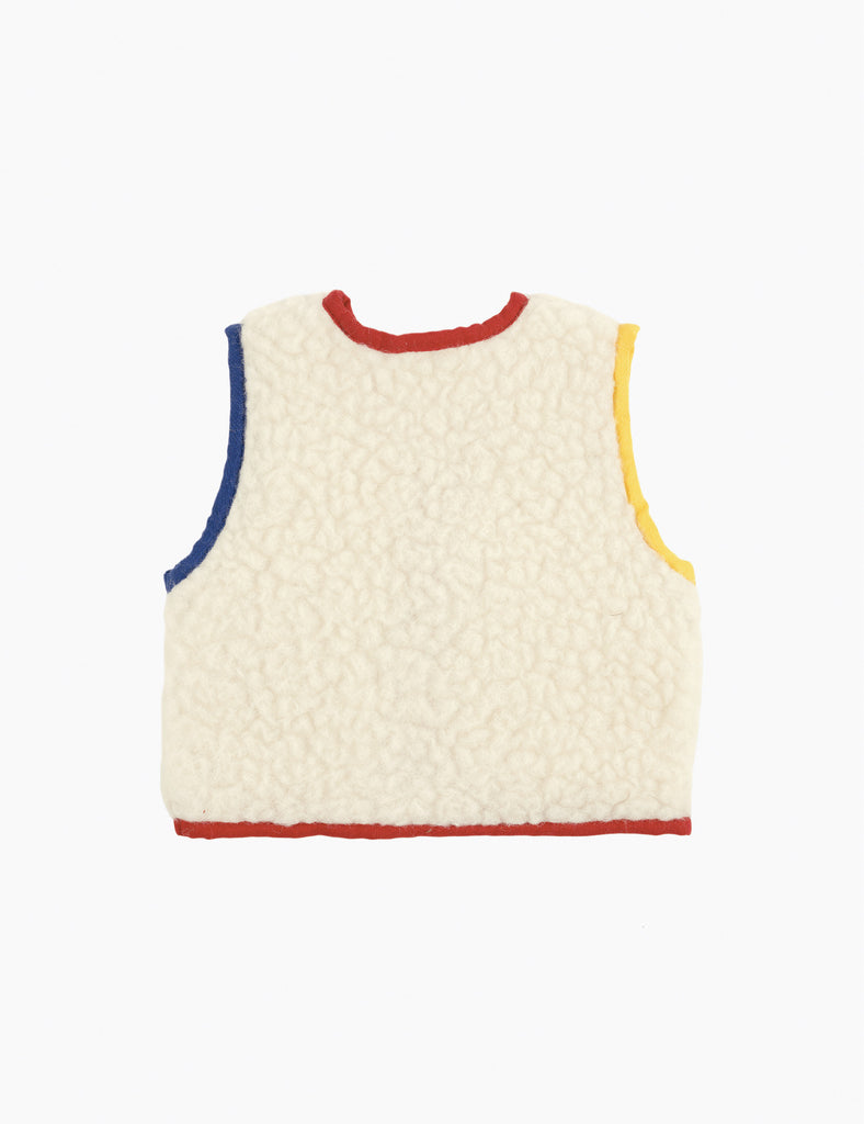 Quilted vest with colorful trim on a white background