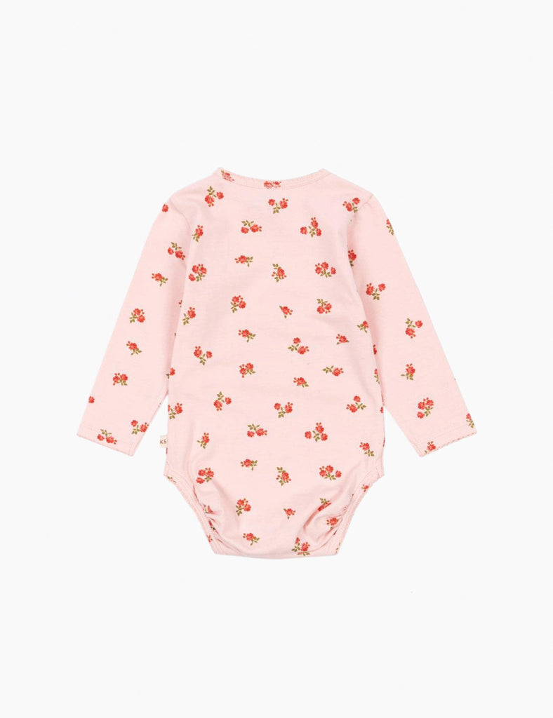 Pink baby onesie with floral pattern on a white background