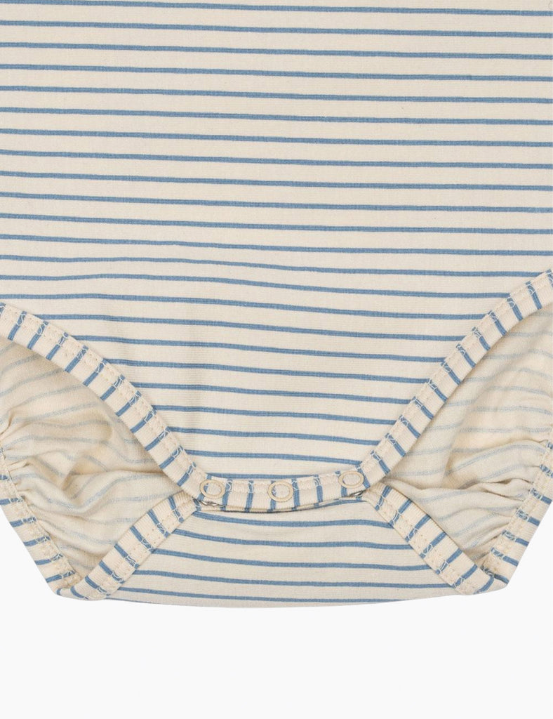 Close-up of a blue and white striped fabric with ruffled edge
