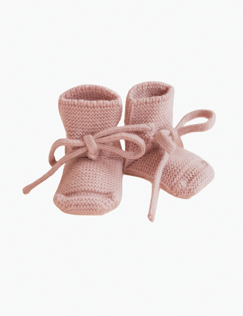 Image of pink booties on a white background.