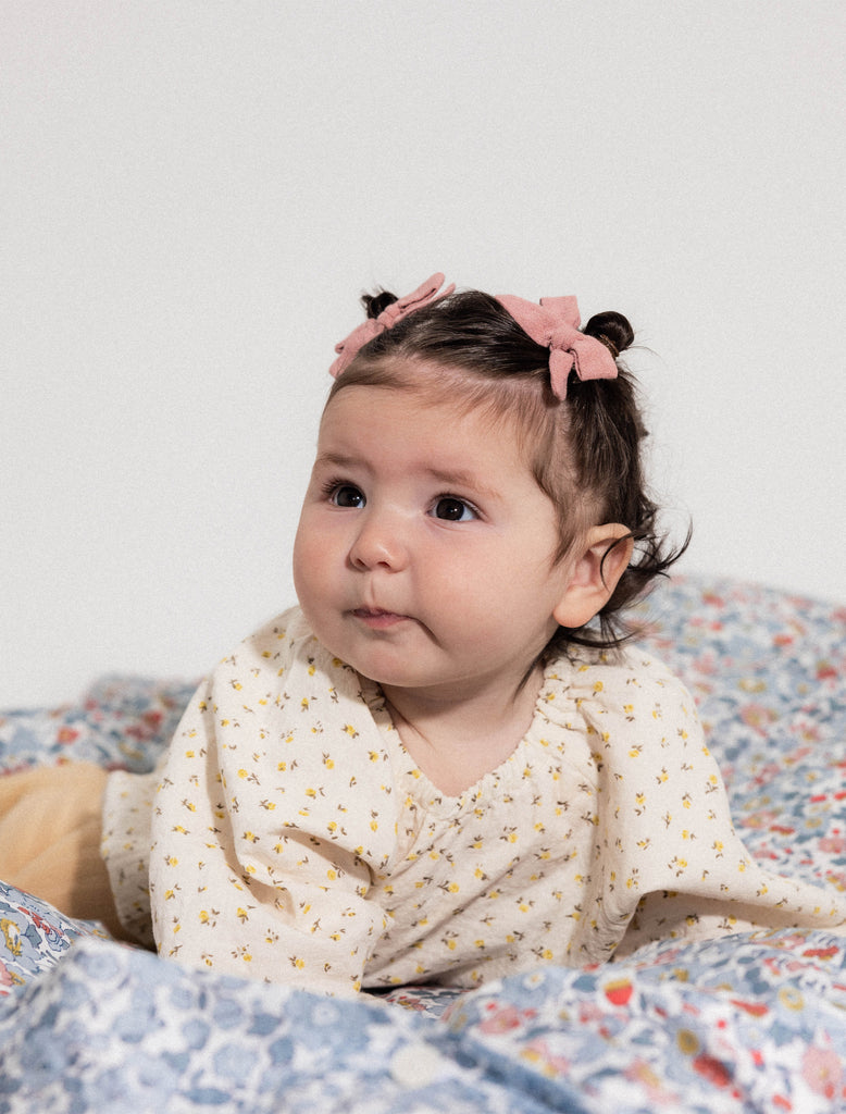 Image of a baby wearing the spring floral romper.