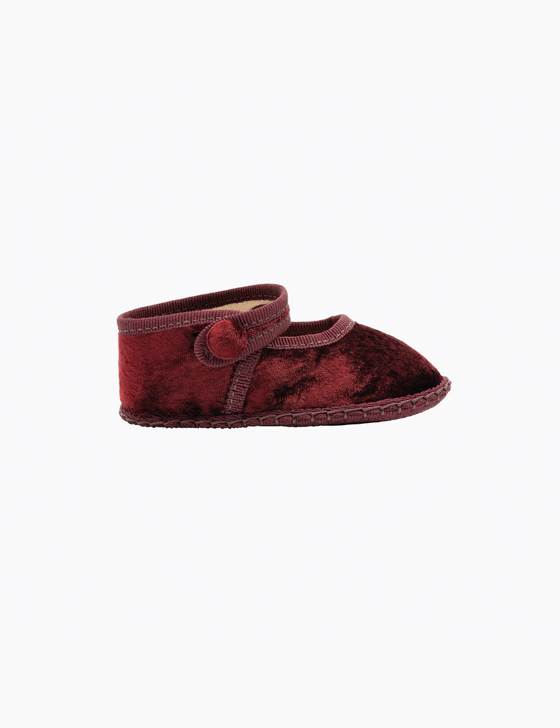 Red velvet baby bootie on a white background
