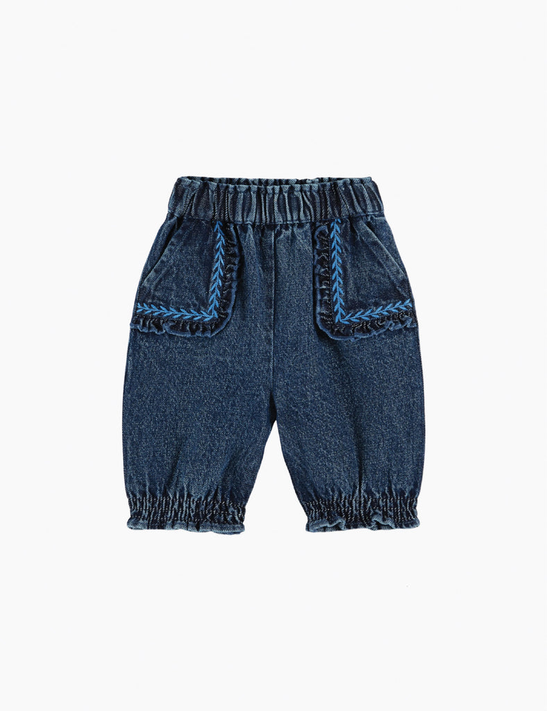 Blue denim baby pants with embroidered details on a white background