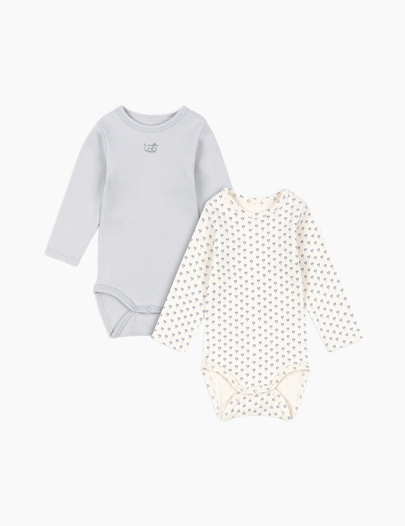 Light blue baby bodysuit with long sleeves and a printed baby bodysuit on a light gray background.