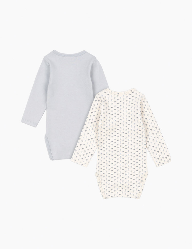 Two baby onesies, one light blue and one with a white pattern, on a white background.
