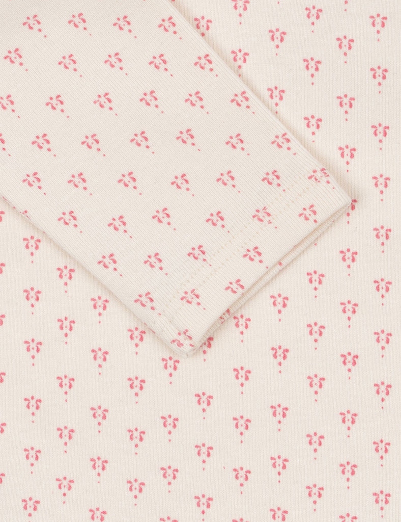 Floral patterned fabric with small pink flowers on a white background