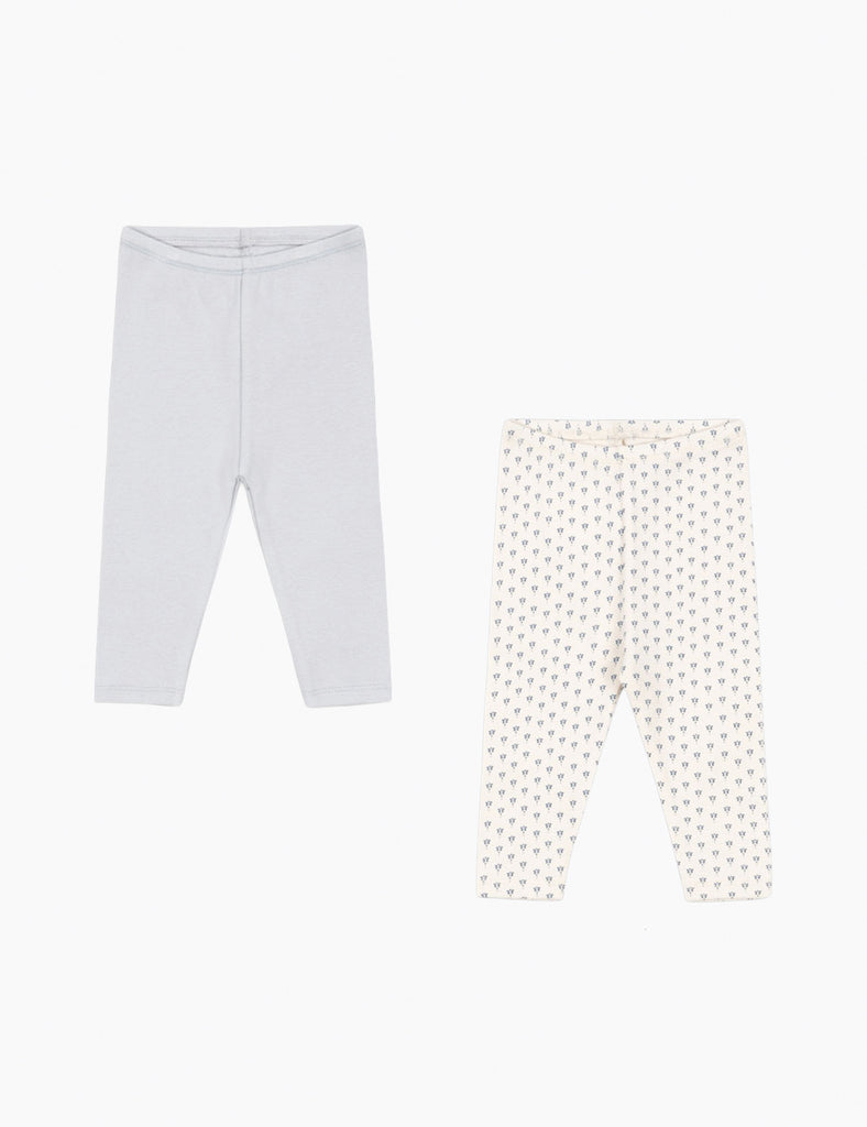Two pairs of baby leggings, one plain white and one with a pattern, on a white background.