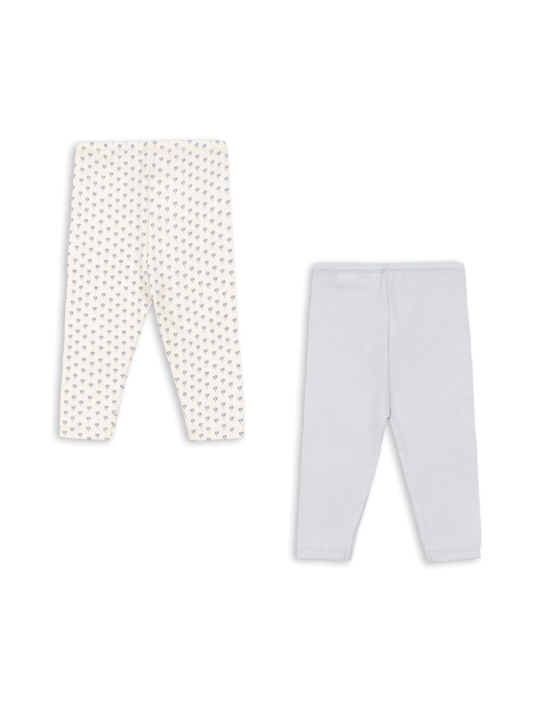 Two pairs of baby leggings, one with a white background and one with a subtle pattern, on a white background.