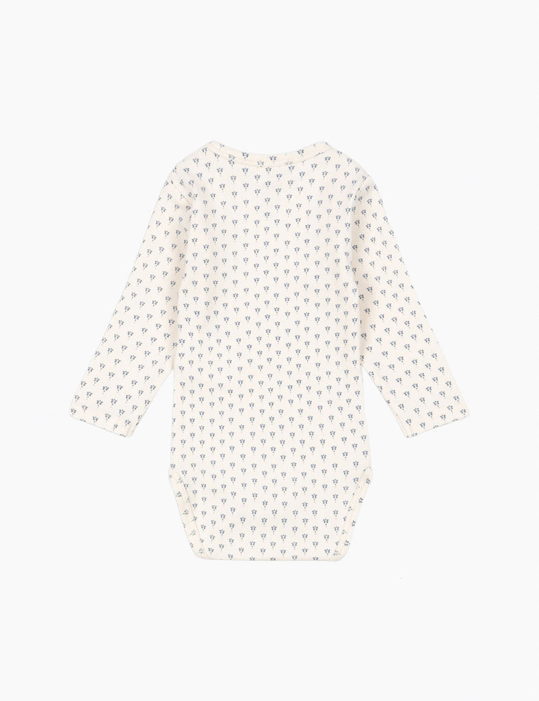 Long-sleeve bodysuit with a subtle pattern on a white background