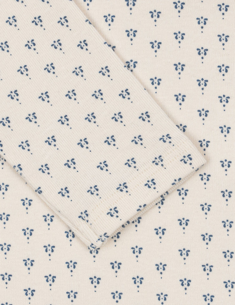White fabric with small blue floral pattern