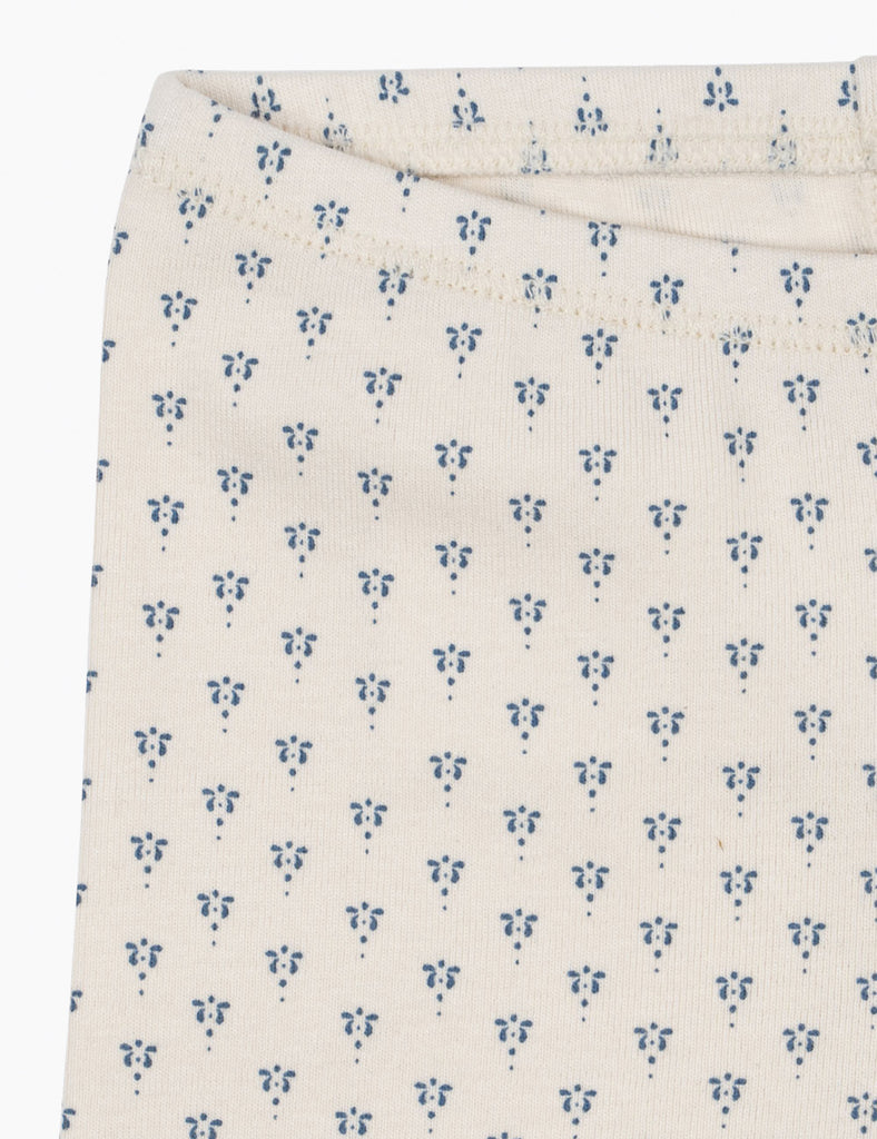 White fabric with blue floral pattern on a white background