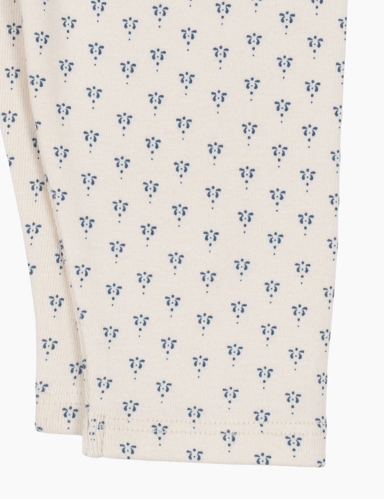 Close-up of a fabric with a blue floral pattern on a white background