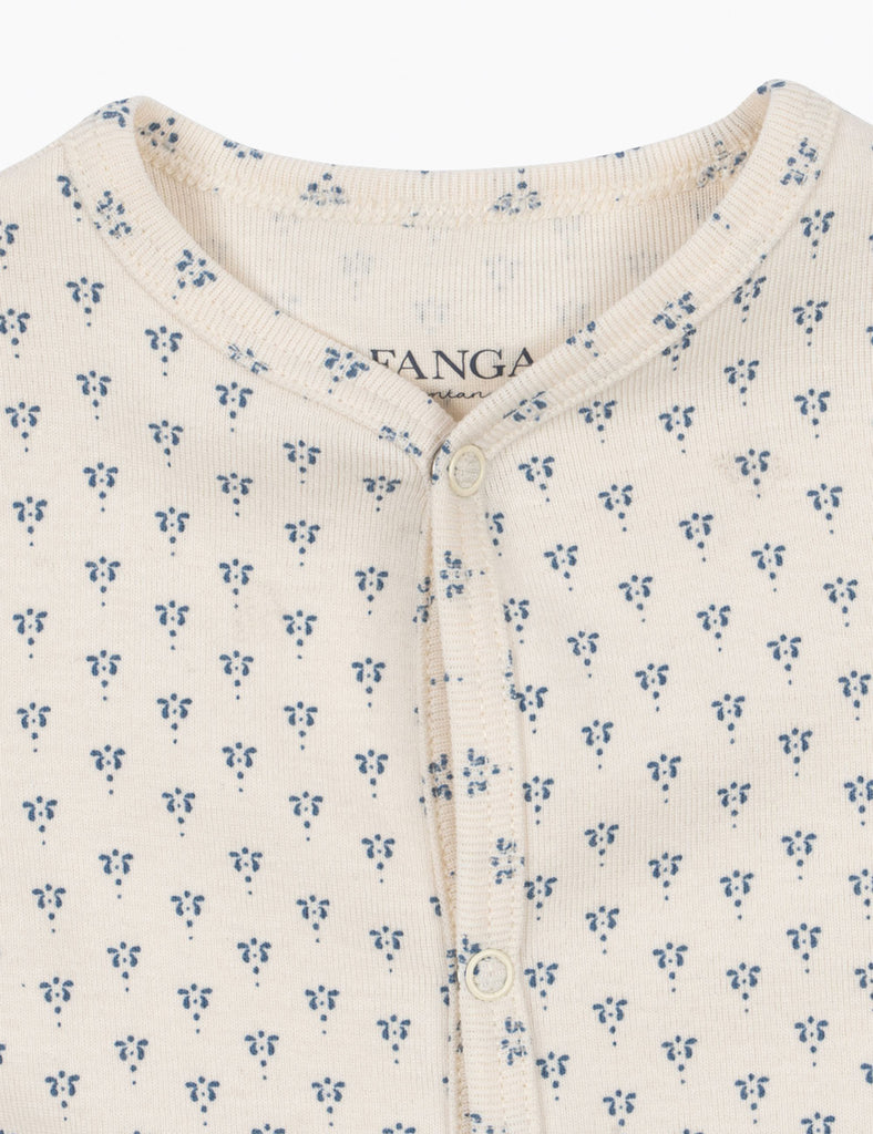 Close-up of a baby onesie with floral pattern and 'FANGA' branding.