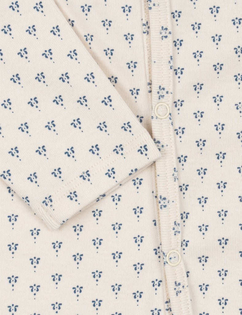 Floral patterned garment with buttons on a white background