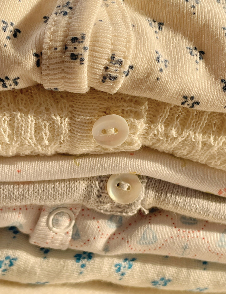 Stack of folded fabric with buttons and floral patterns
