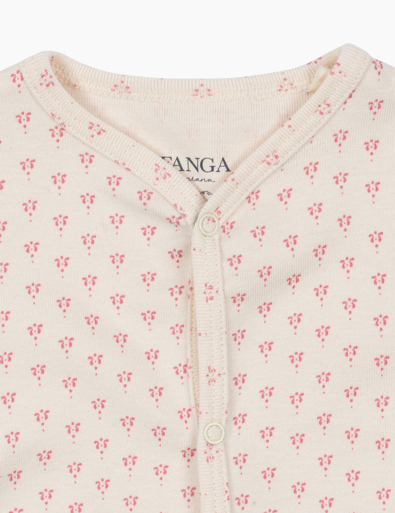 Close-up of a baby onesie with floral pattern and 'FANGA' branding.