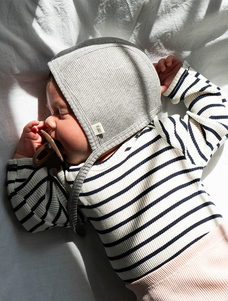 Image of an infant wearing the Bloom Silk Knit Bonnet in Grey Melange.