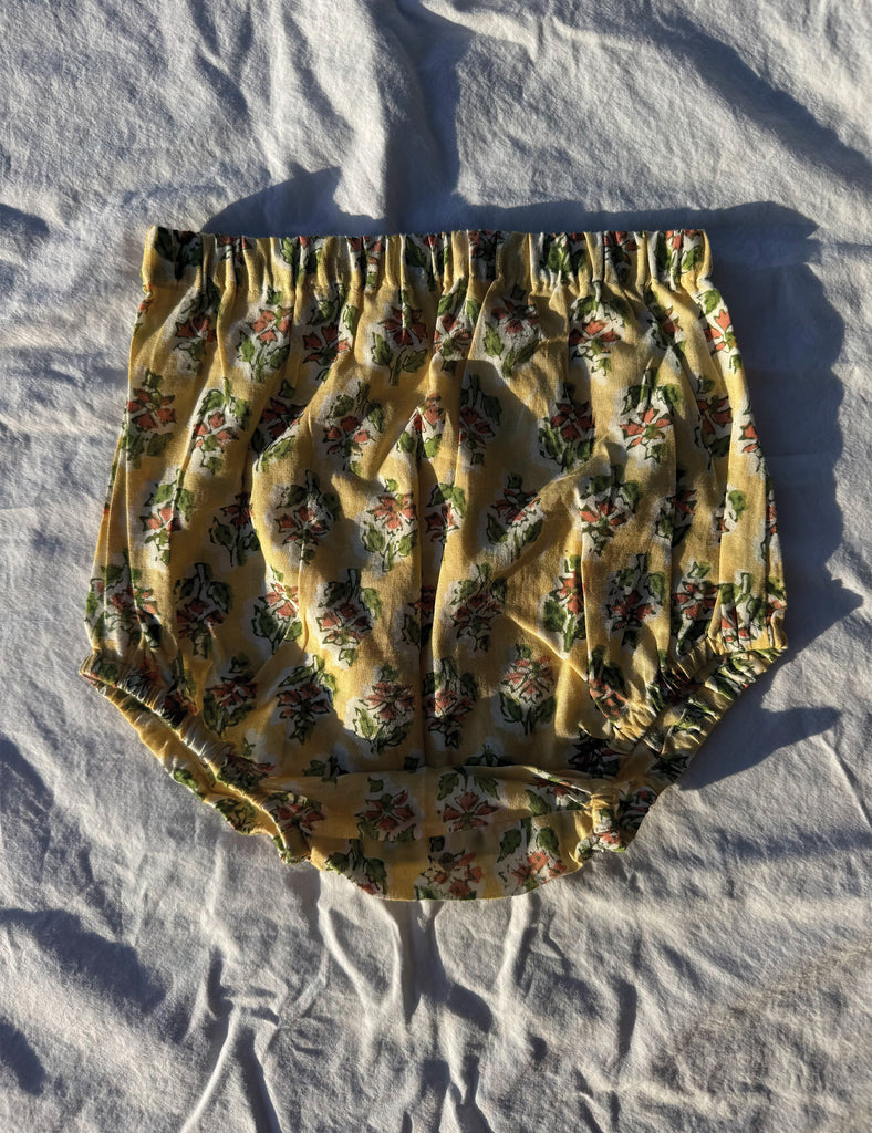 Floral-patterned bloomers on a white fabric background