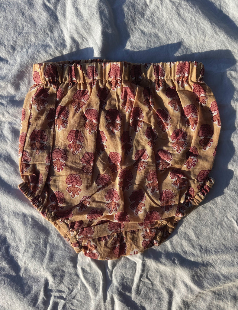 Floral-patterned bloomers on a white fabric background