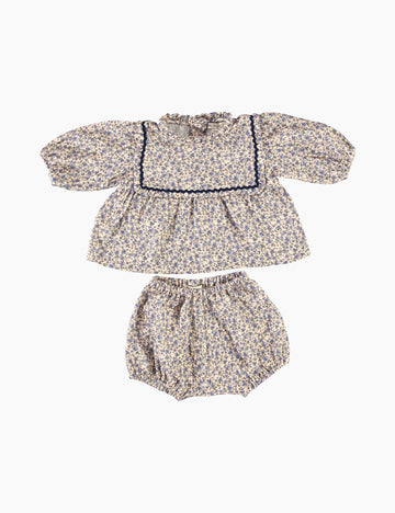 Floral baby outfit with bloomer and top on a white background