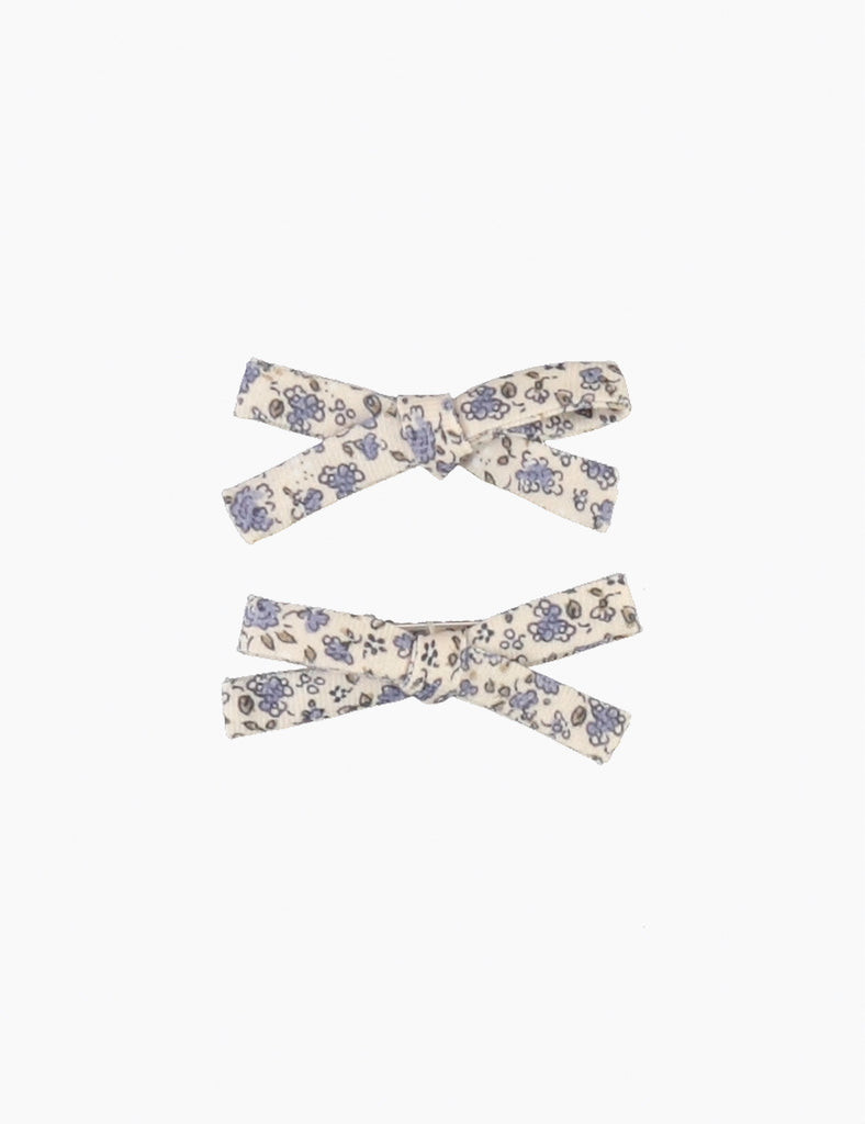 Two floral-patterned hair bows on a white background