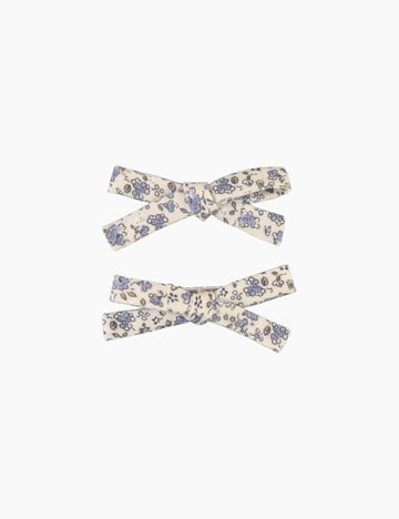 Two floral-patterned hair bows on a white background