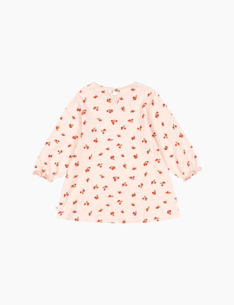 Pink dress with red floral pattern on a white background