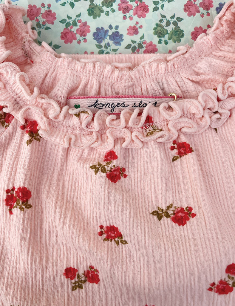 Pink fabric with floral patterns and a Konges Slojd label.