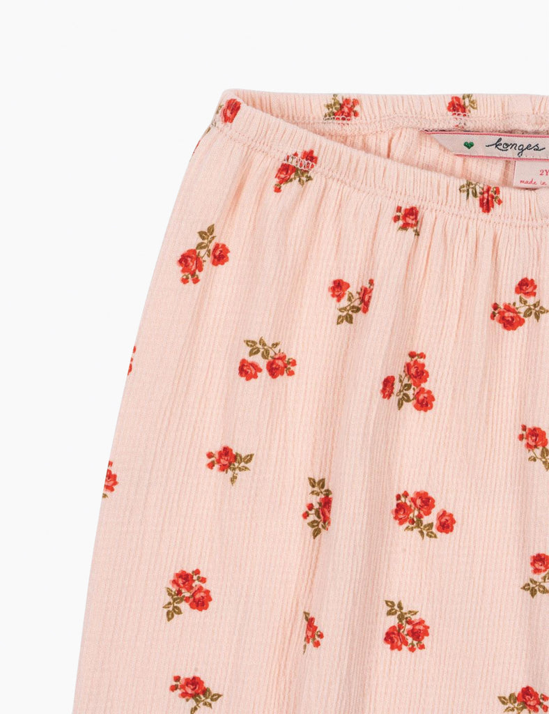 Pink floral patterned fabric with a visible brand label on a white background