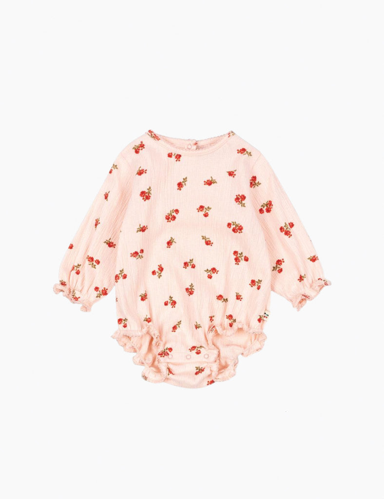 Pink baby romper with red floral pattern on a white background